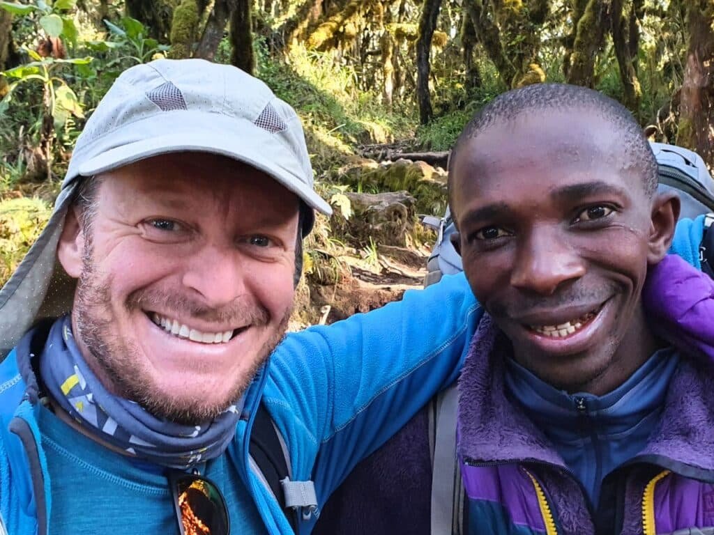 Mount Kilimanjaro guide smiling with his client